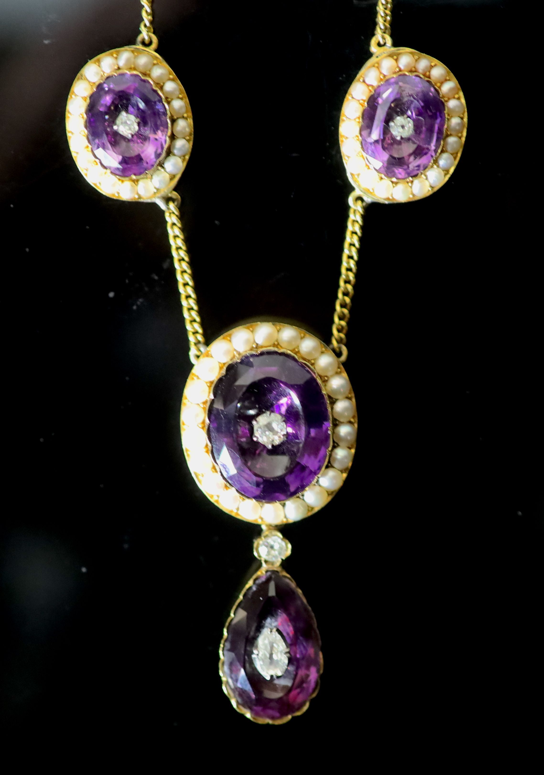 A Victorian style gold, amethyst, split pearl and old cut diamond cluster set drop necklace